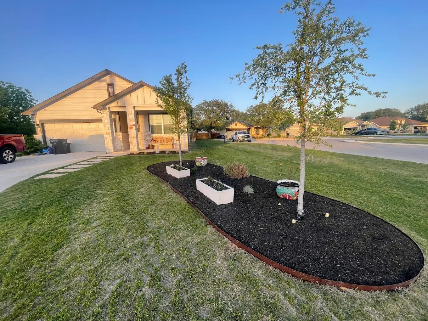 Custom metal landscape edging running along a flower bed